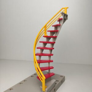 Escalera de caracol de color gris con la barandilla de color amarillo