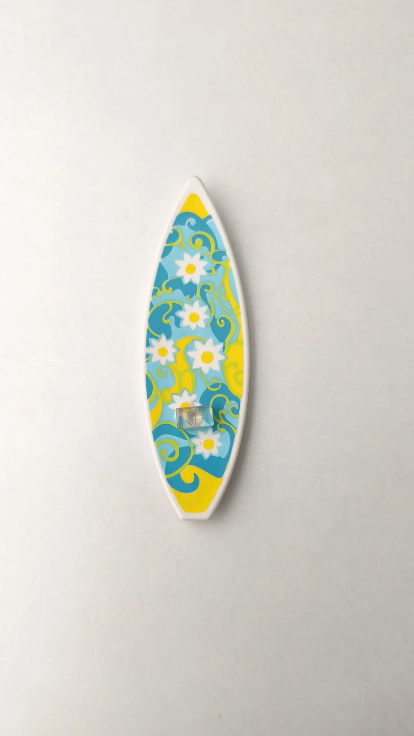 Tabla de surf turquesa con flores amarillas